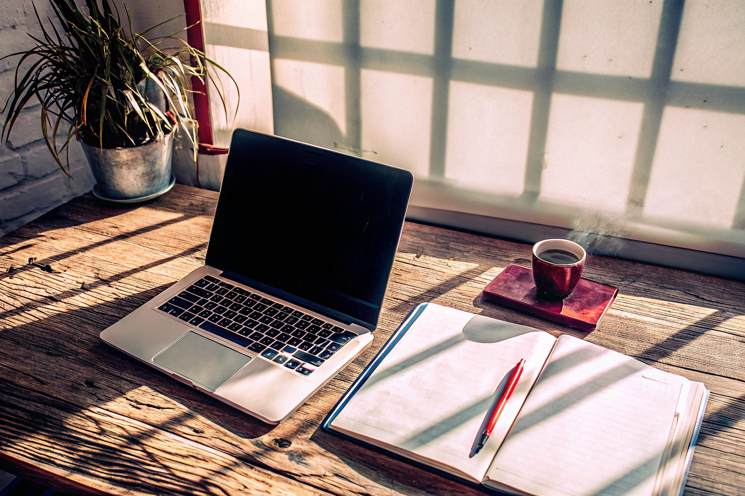 Ein Blogger, der an einem Laptop arbeitet und Notizen macht. Blogger bei der Arbeit
